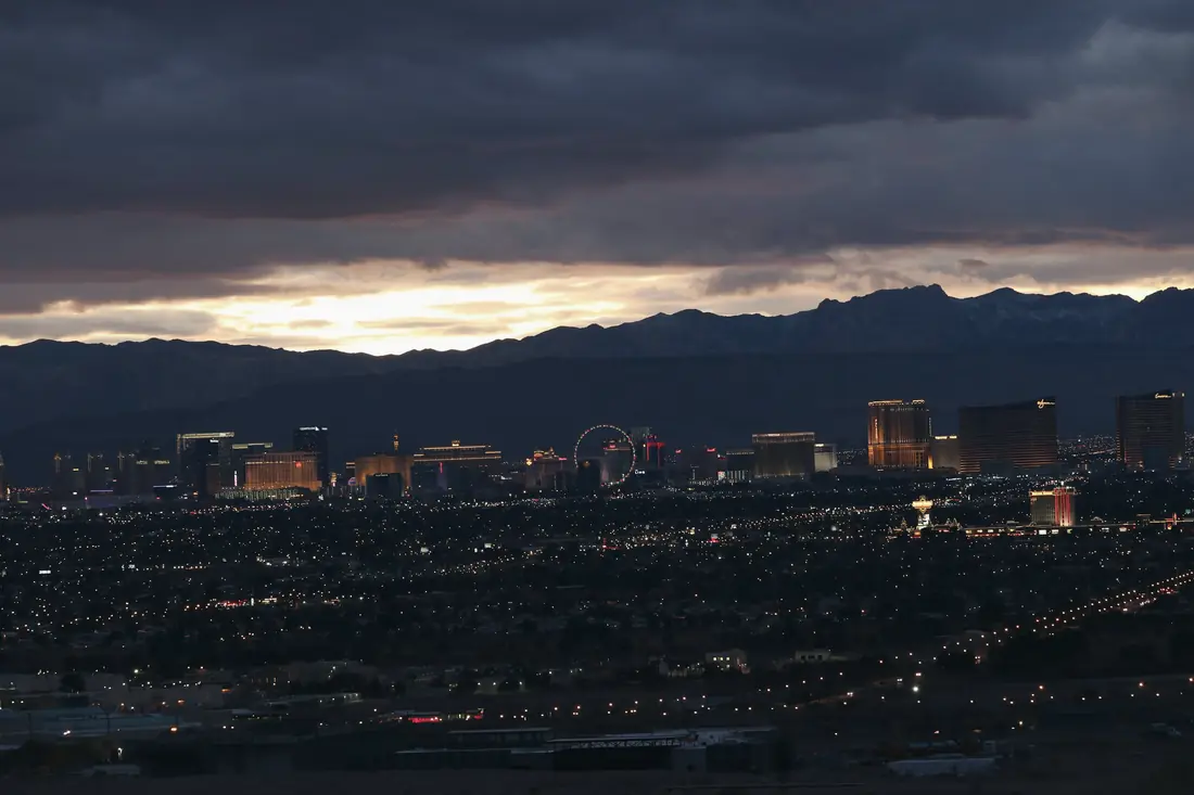 Las Vegas at dusk under heavy clouds, seen from the hills